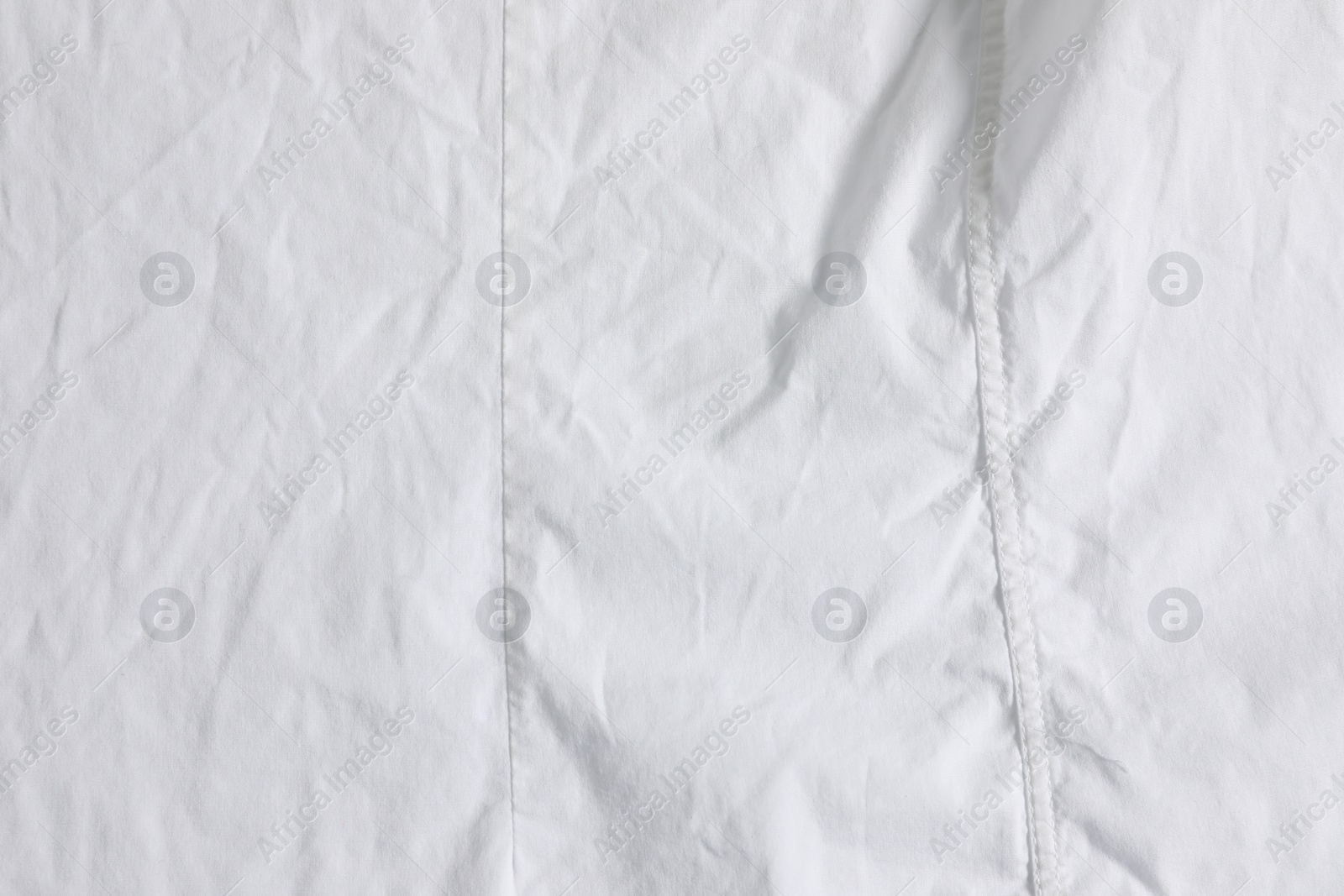 Photo of Crumpled white fabric as background, top view