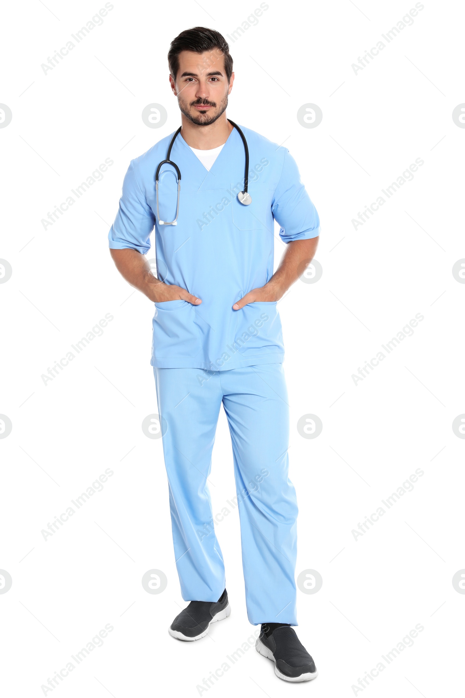 Photo of Young male doctor in uniform with stethoscope on white background. Medical service