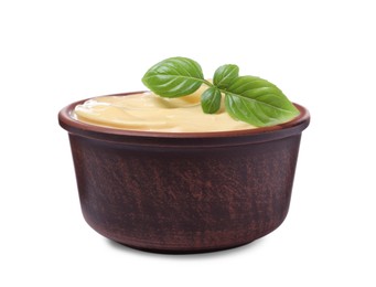 Photo of Tasty cheese sauce with basil in bowl isolated on white