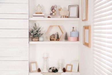 Photo of Wall shelves with beautiful Christmas decor indoors. Interior design