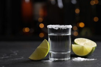 Photo of Mexican Tequila shot with lime slices and salt on bar counter