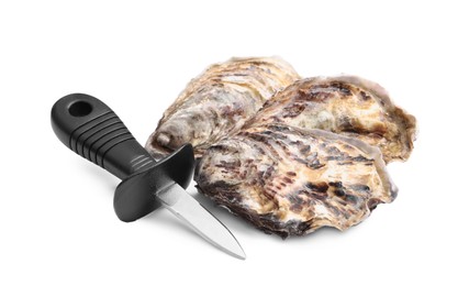 Photo of Fresh raw oysters and knife on white background
