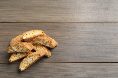 Traditional Italian almond biscuits (Cantucci) on wooden table, flat lay. Space for text