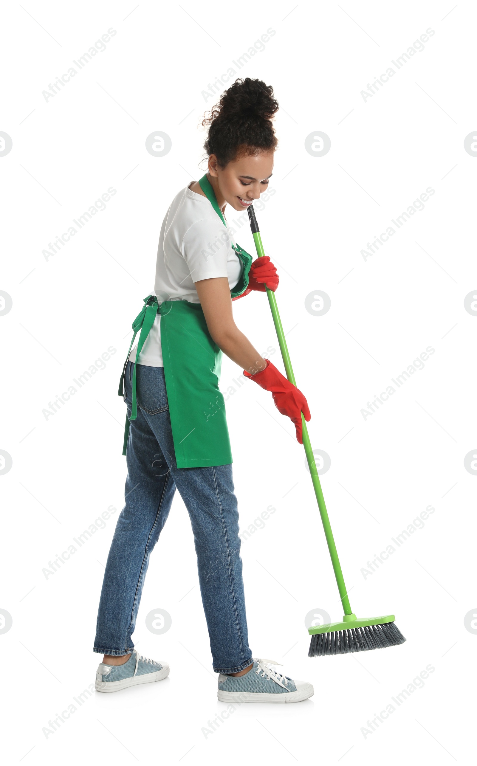 Photo of African American woman with green broom on white background