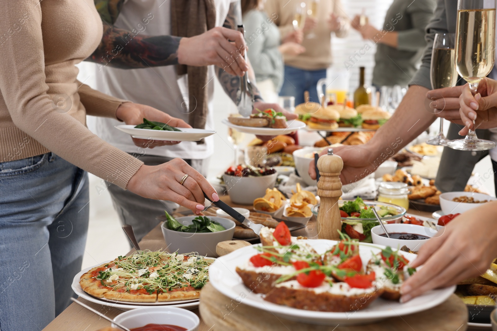 Photo of People near buffet table with food indoors, closeup. Brunch setting