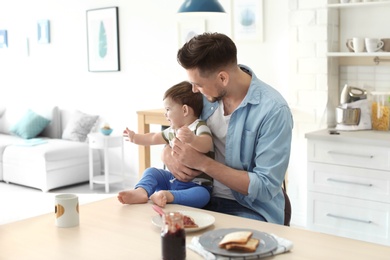 Photo of Dad and son at table in kitchen