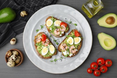 Photo of Delicious sandwiches with guacamole, shrimps and eggs on wooden table, flat lay