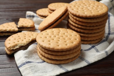 Photo of Tasty sandwich cookies on wooden table, closeup