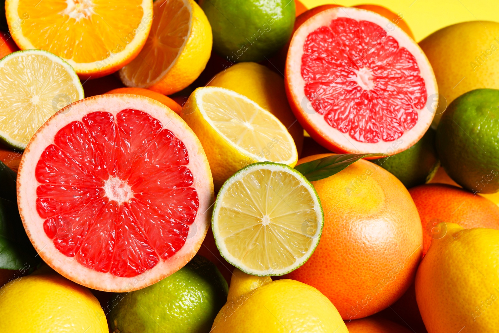 Photo of Different fresh citrus fruits as background, closeup