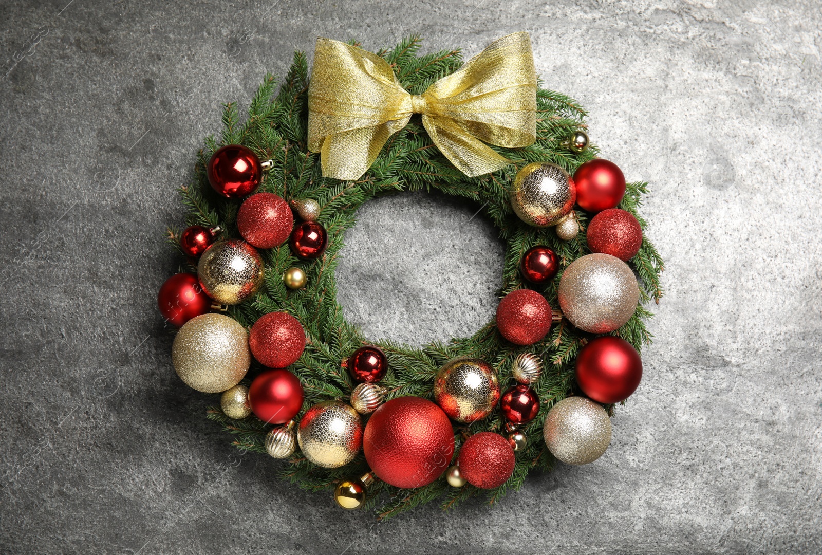 Photo of Beautiful Christmas wreath with festive decor on grey background