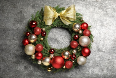 Photo of Beautiful Christmas wreath with festive decor on grey background