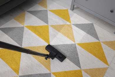 Image of Hoovering carpet with vacuum cleaner in room, above view. Clean trace on dirty surface