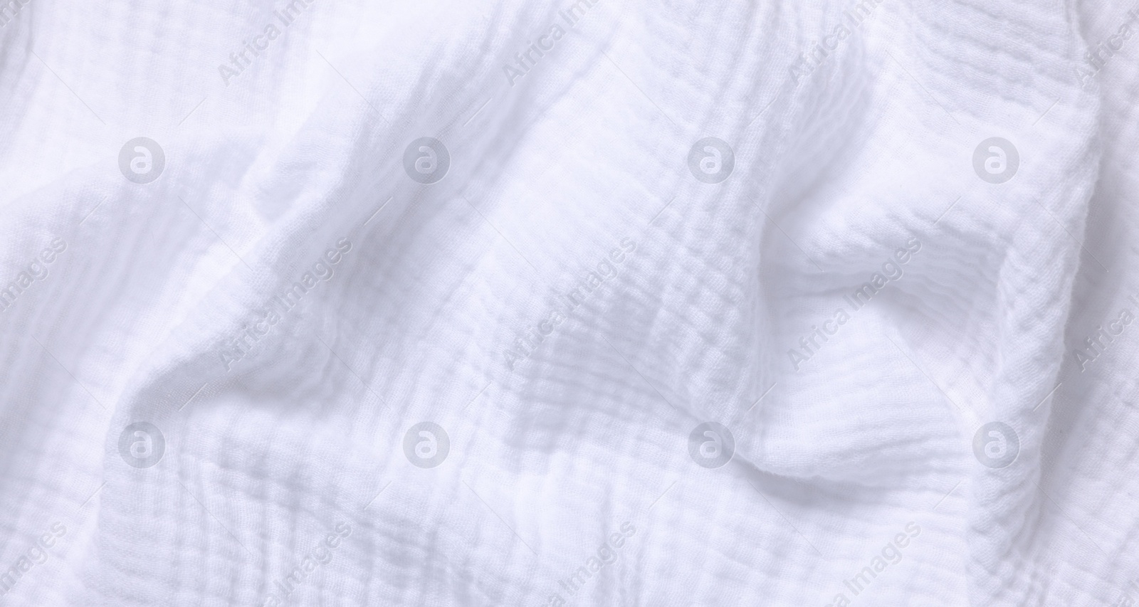 Photo of Texture of white crumpled fabric as background, top view