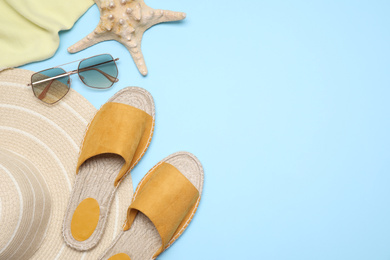 Photo of Flat lay composition with beach objects on light blue background. Space for text