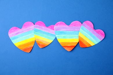 Rainbow hearts on color background, top view. Gay symbol