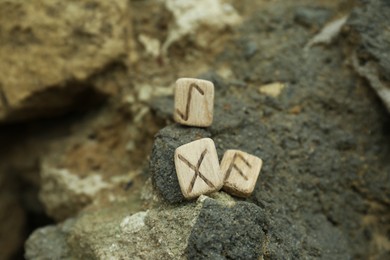 Wooden runes on stone outdoors, closeup view