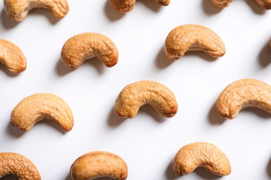 Photo of Tasty roasted cashew nuts on white background, top view