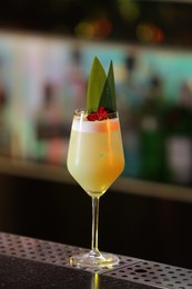 Photo of Fresh alcoholic cocktail in glass on bar counter