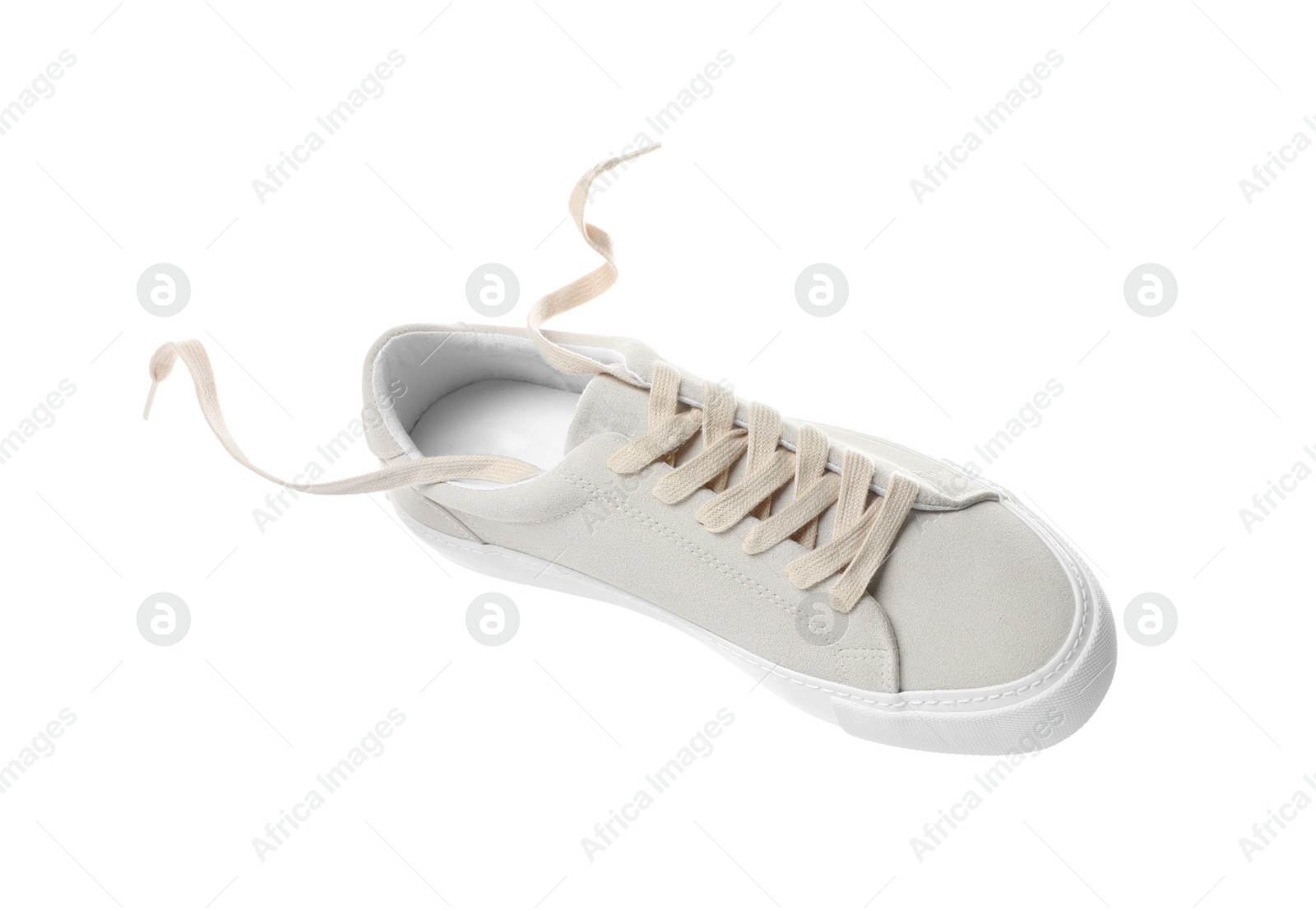 Photo of One stylish beige sneaker isolated on white