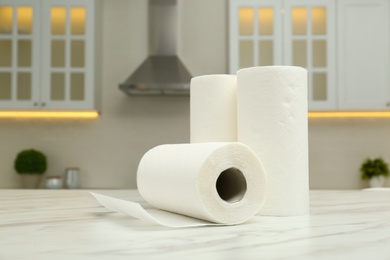 Photo of Paper towels on white marble table in kitchen