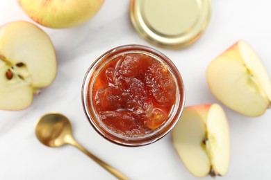 Photo of Delicious apple jam in jar and fresh fruits on white table, flat lay