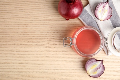 Photo of Flat lay composition with onion syrup in jar and space for text on table