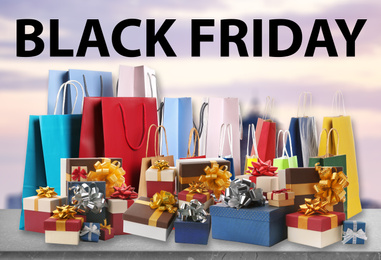 Image of Black Friday. Many gift boxes and shopping bags against blurred background