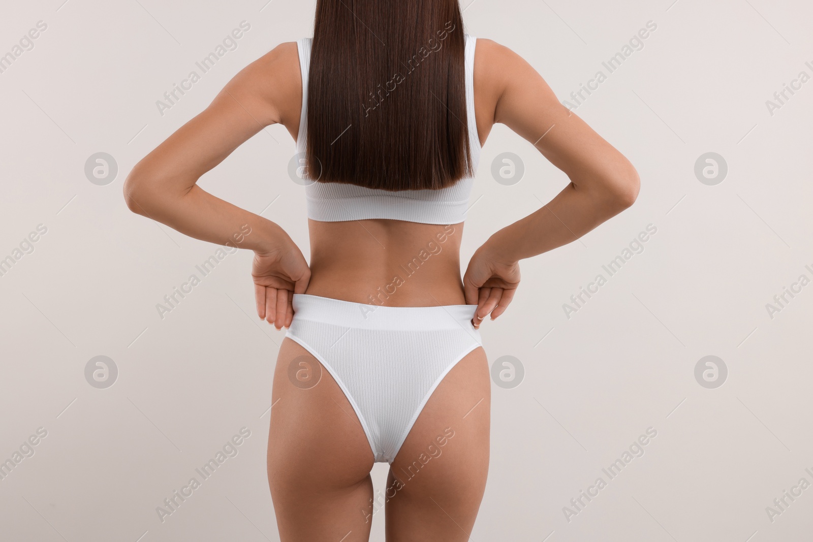 Photo of Young woman in stylish bikini on white background, closeup