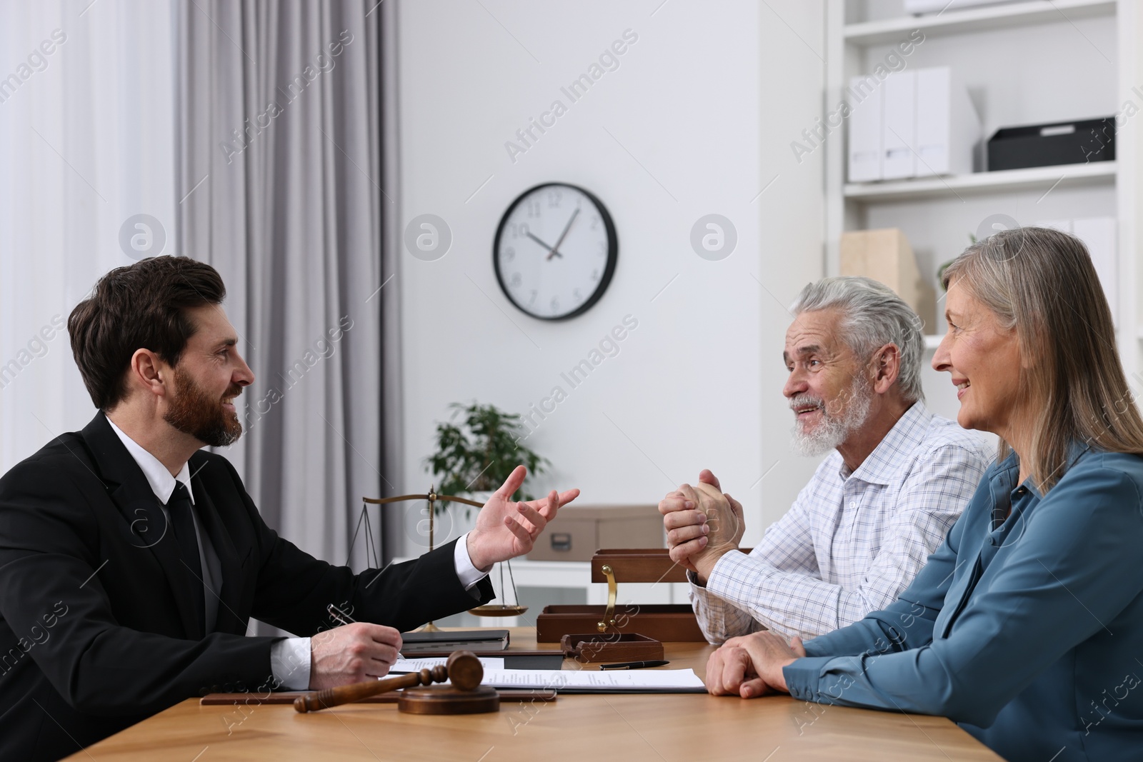 Photo of Senior couple having meeting with lawyer in office