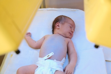 Photo of Newborn child under ultraviolet light in hospital