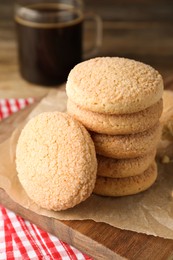 Photo of Delicious sugar cookies on wooden board, closeup