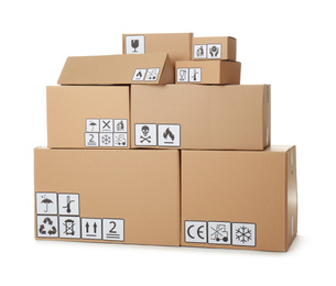 Photo of Stack of cardboard boxes with different packaging symbols on white background. Parcel delivery