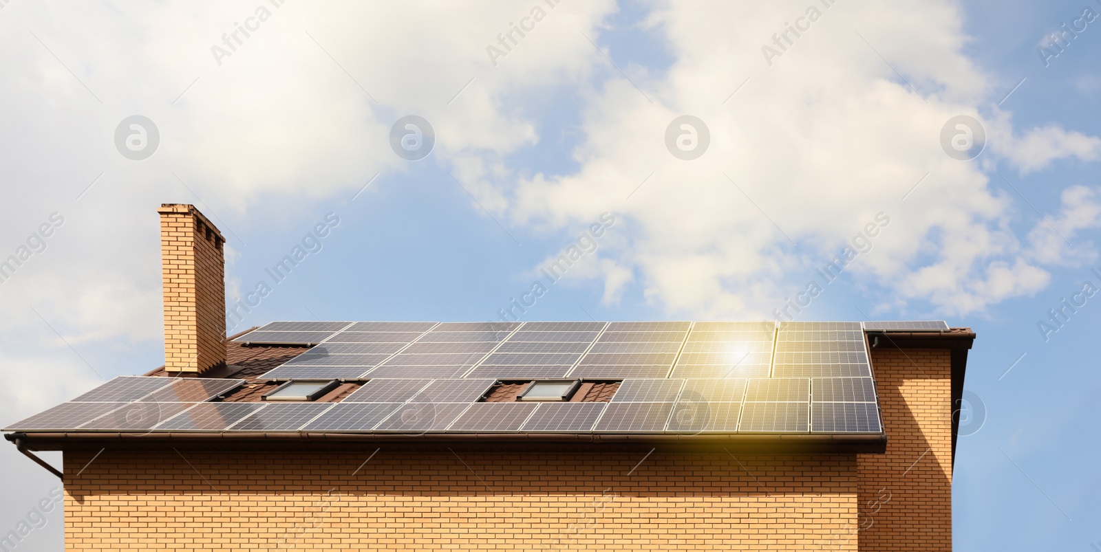 Photo of Building with installed solar panels on roof. Alternative energy source