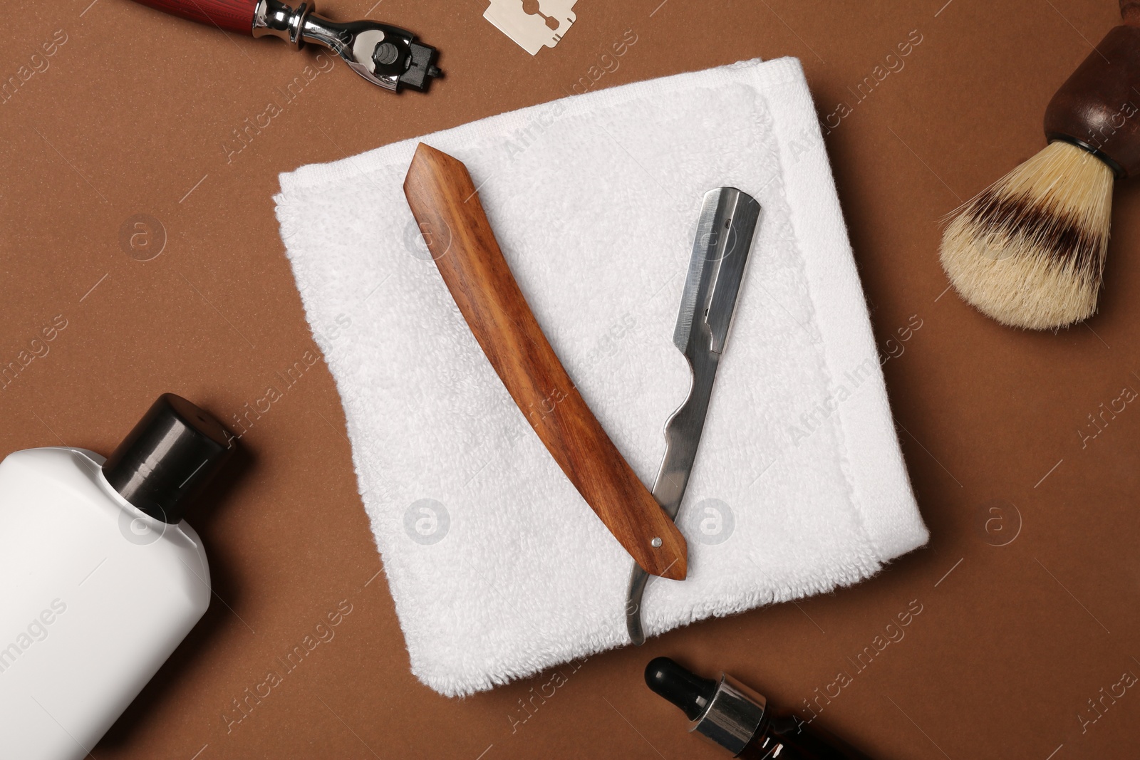 Photo of Set of men's shaving tools on brown background, flat lay