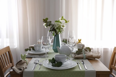 Beautiful Easter table setting with festive decor indoors