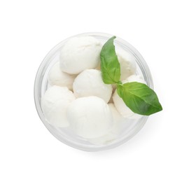 Photo of Bowl with mozzarella cheese balls and basil on white background, top view