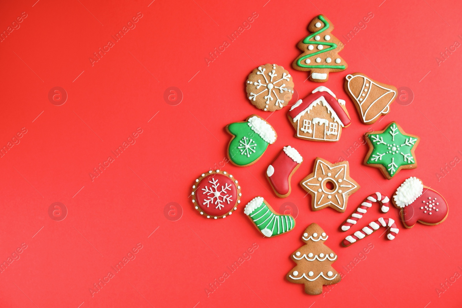 Photo of Christmas tree shape made of tasty homemade cookies on color background, top view