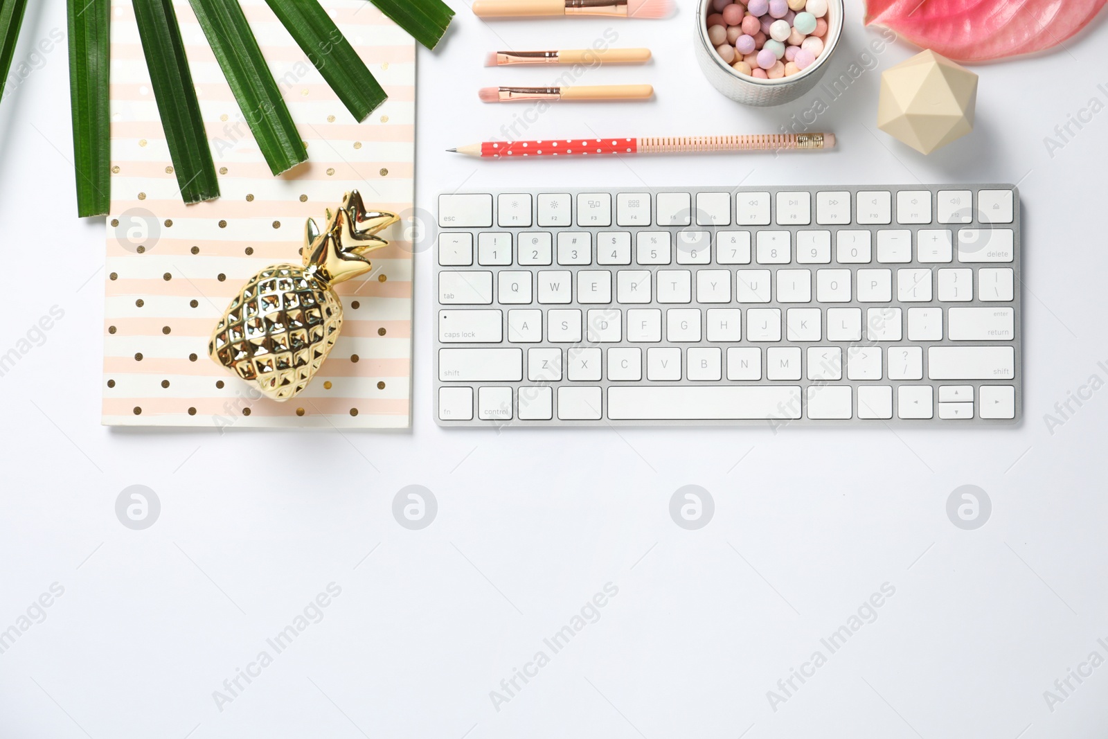 Photo of Creative flat lay composition with tropical flower, stationery and computer keyboard on white background