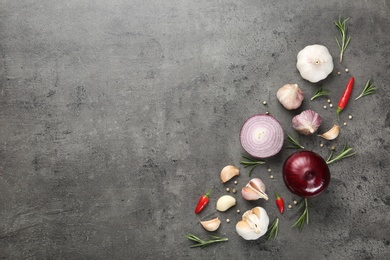 Flat lay composition with garlic, onion and space for text on table