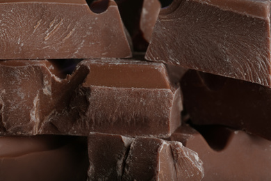 Photo of Pieces of milk chocolate as background, closeup