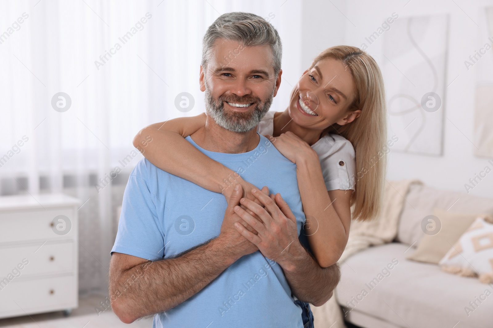 Photo of Portrait of happy affectionate couple at home. Romantic date