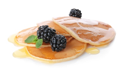 Tasty pancakes with maple syrup and fresh berries on white background