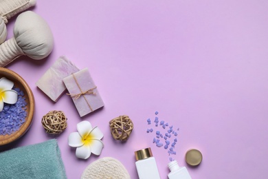 Flat lay composition with spa items on violet background. Space for text