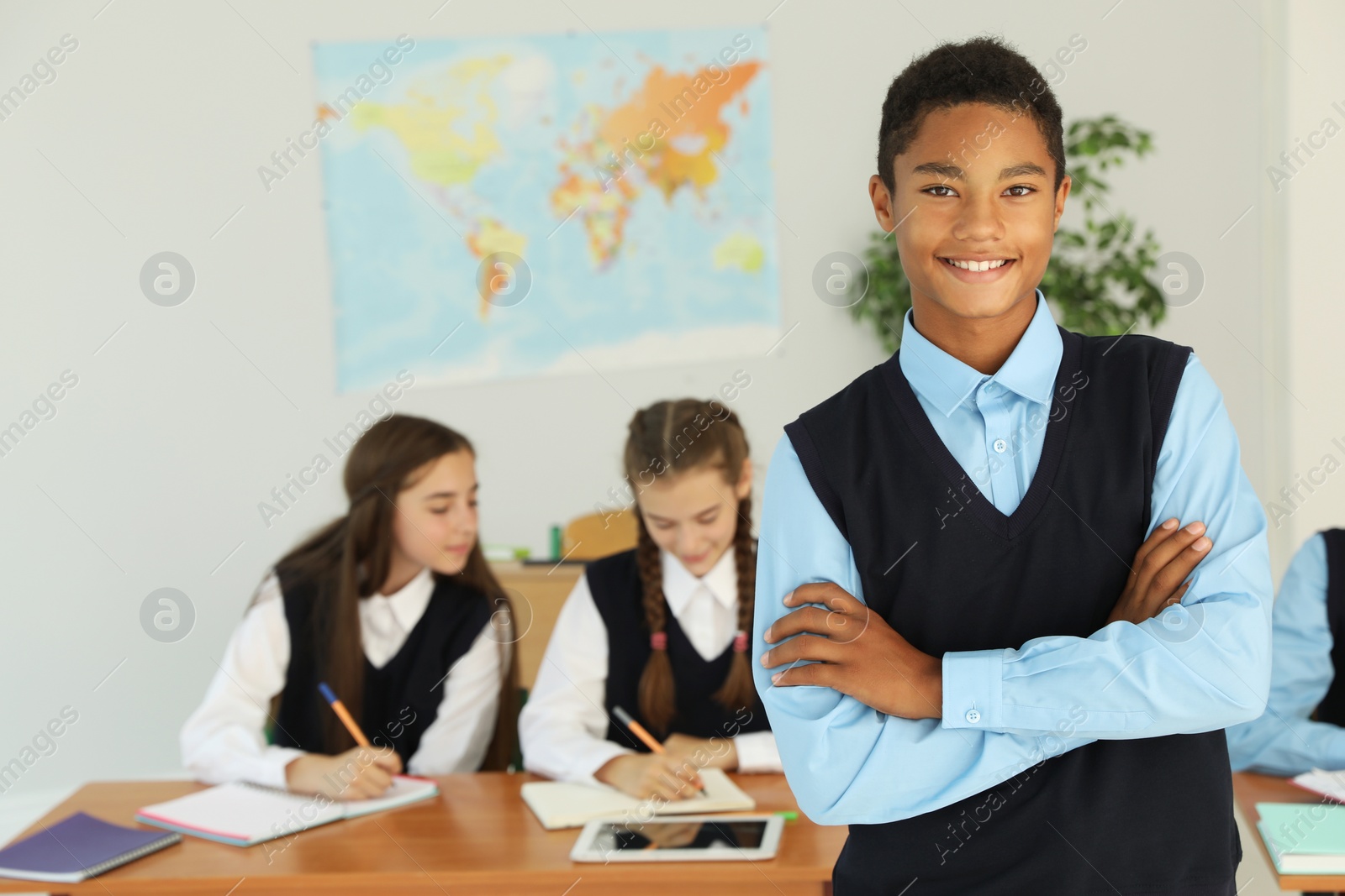 Photo of African American teenage student in classroom. Stylish school uniform
