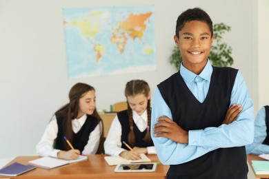 African American teenage student in classroom. Stylish school uniform