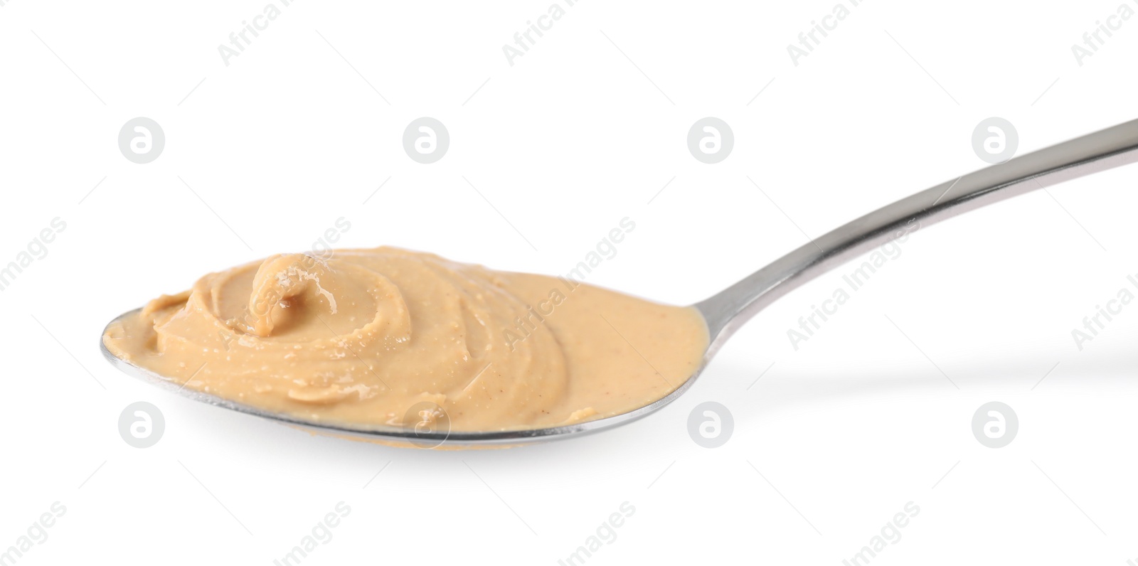 Photo of Delicious nut butter in spoon isolated on white