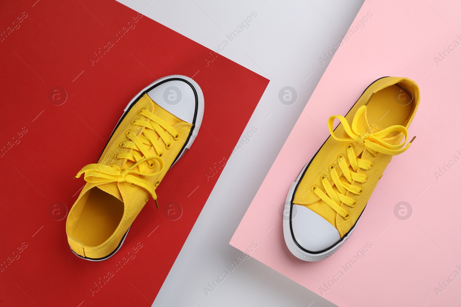 Photo of Stylish sneakers on color background, flat lay