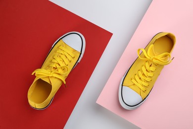 Photo of Stylish sneakers on color background, flat lay