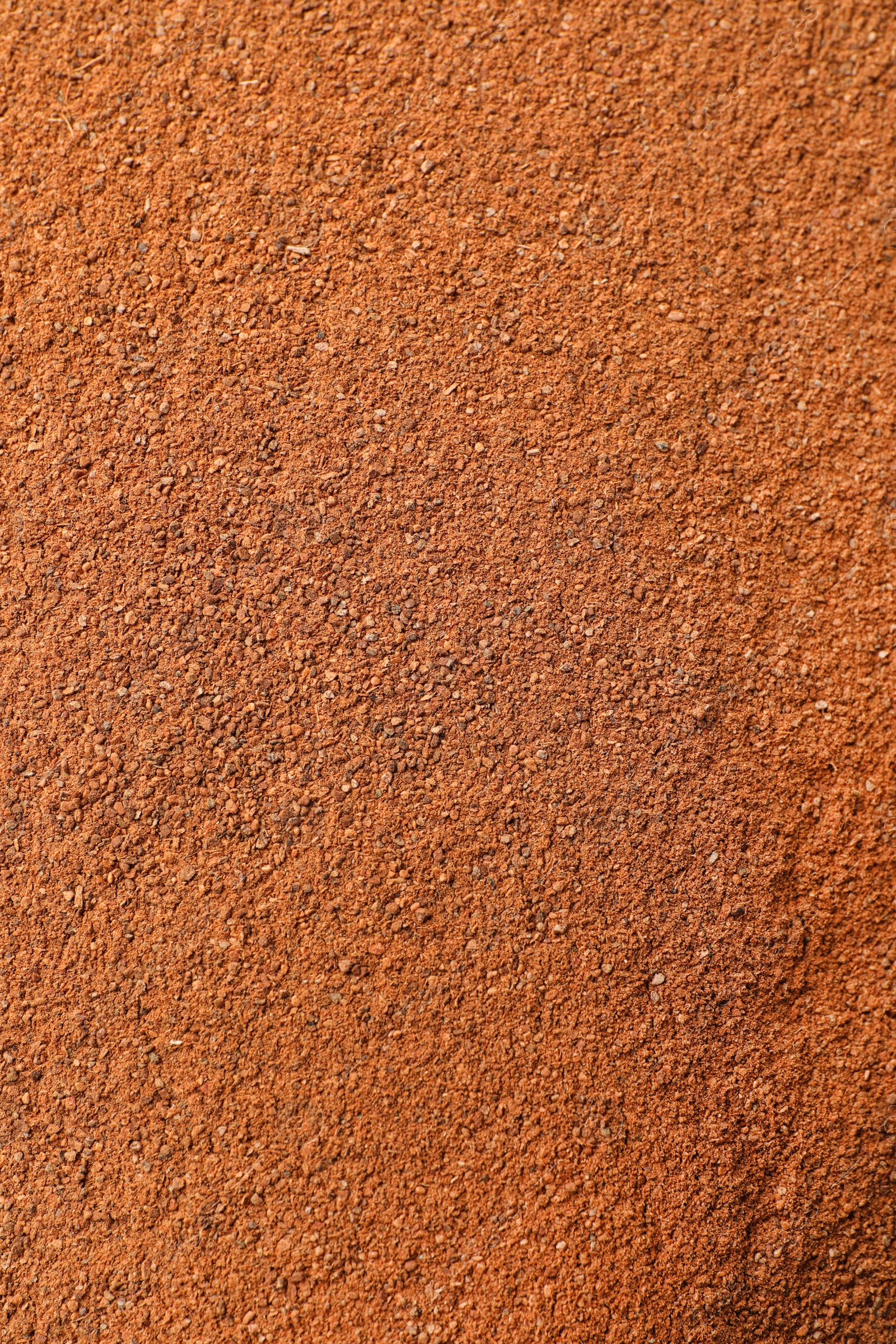 Photo of Aromatic cinnamon powder as background, top view