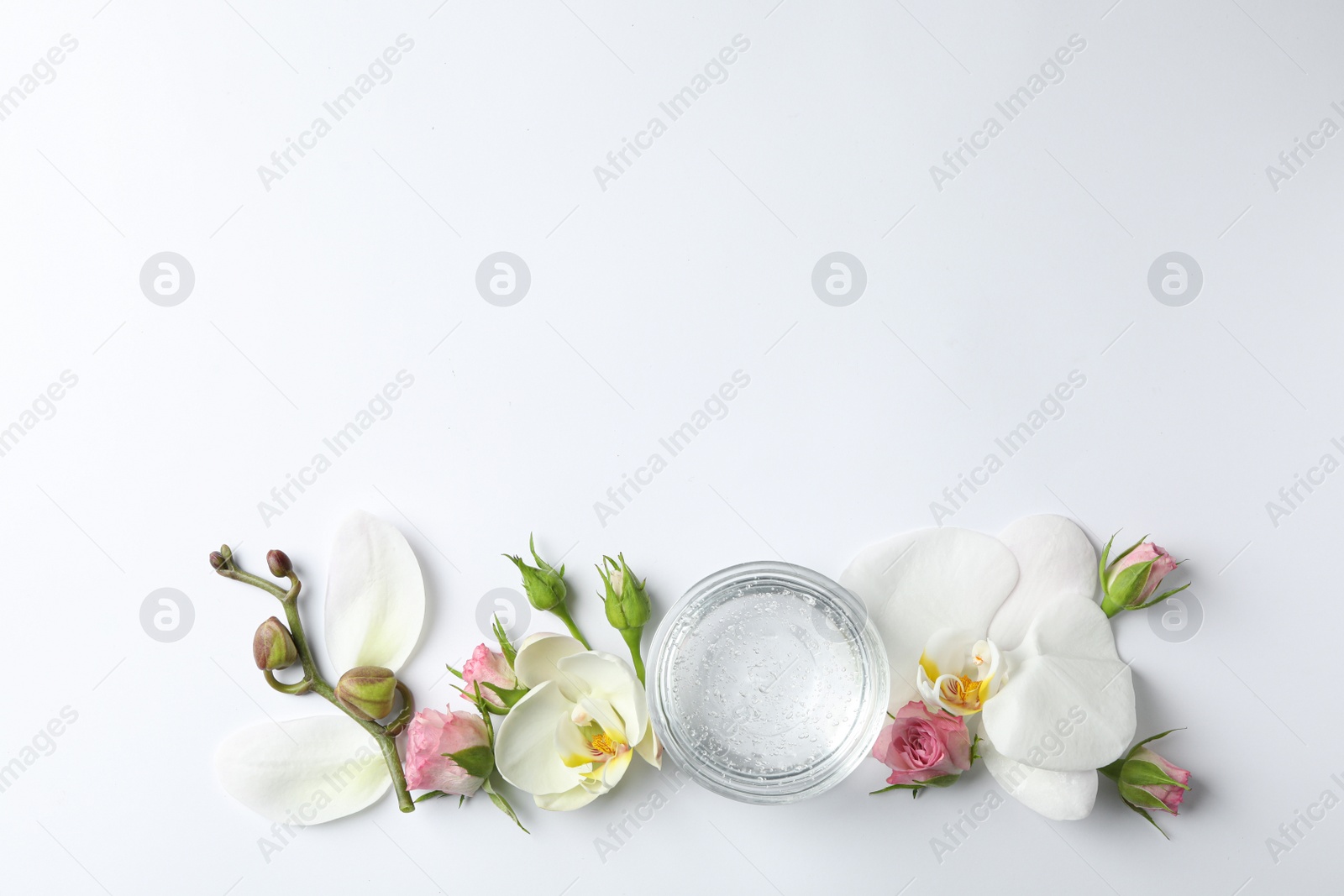 Photo of Composition with cosmetic gel and beautiful flowers on white background, top view